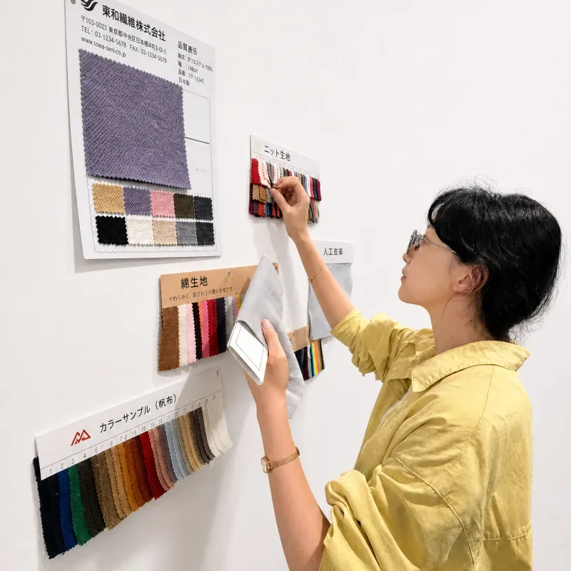 Comparing fabric swatches pinned to a wall